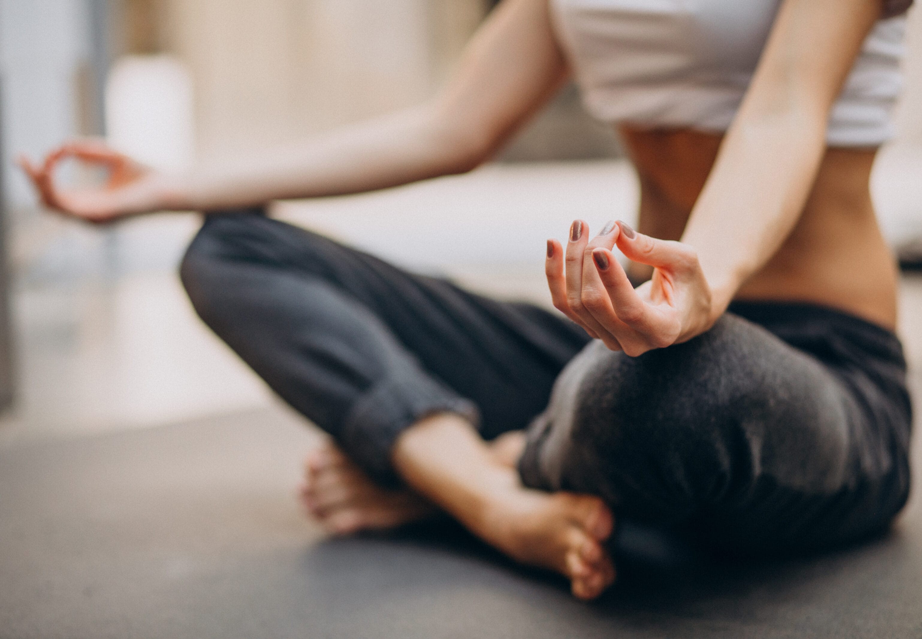Young woman practicing yoga at home